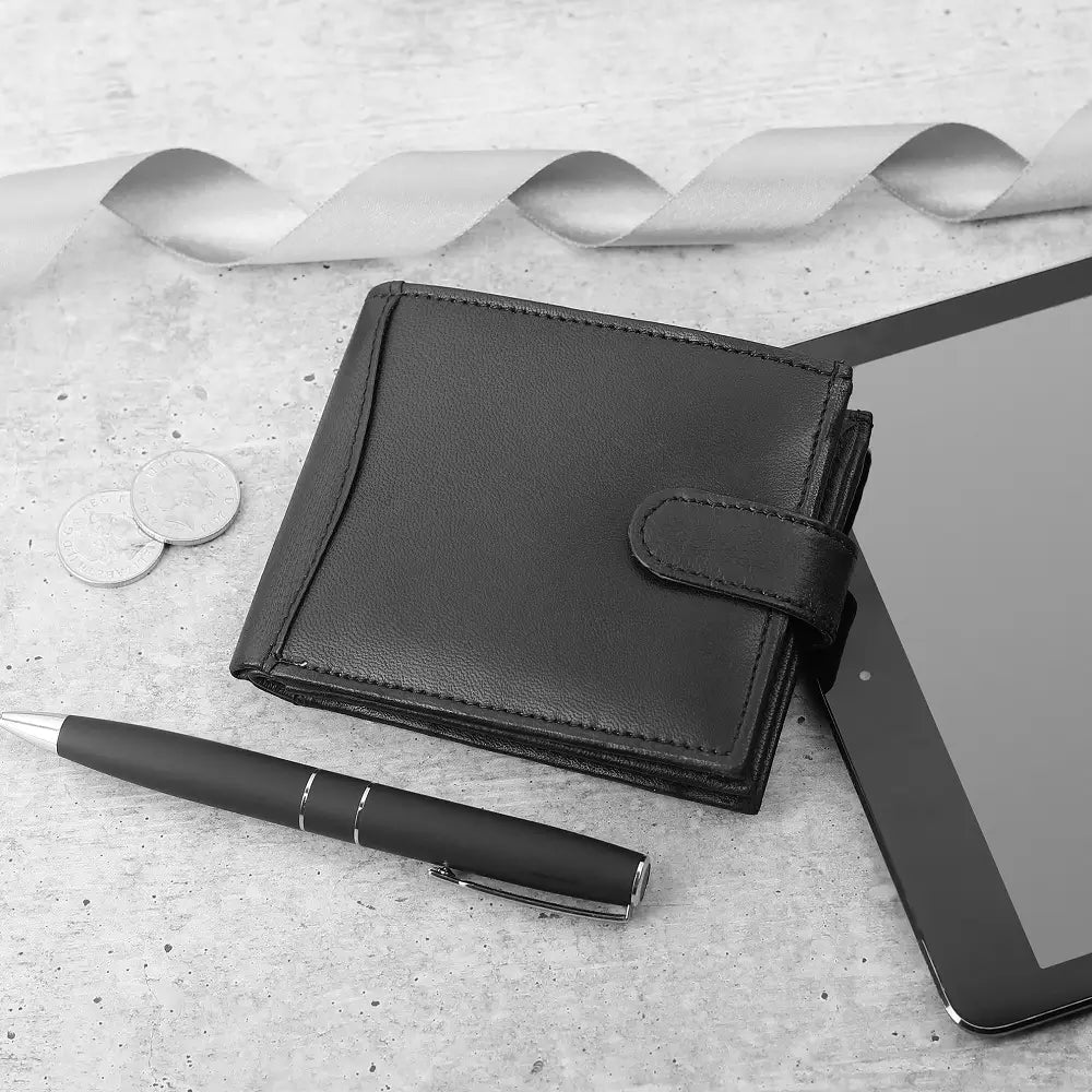 Flat lay of Basic Wallet Style 340 – RFID leather bifold wallet with tab closure and coin pocket placed beside daily accessories