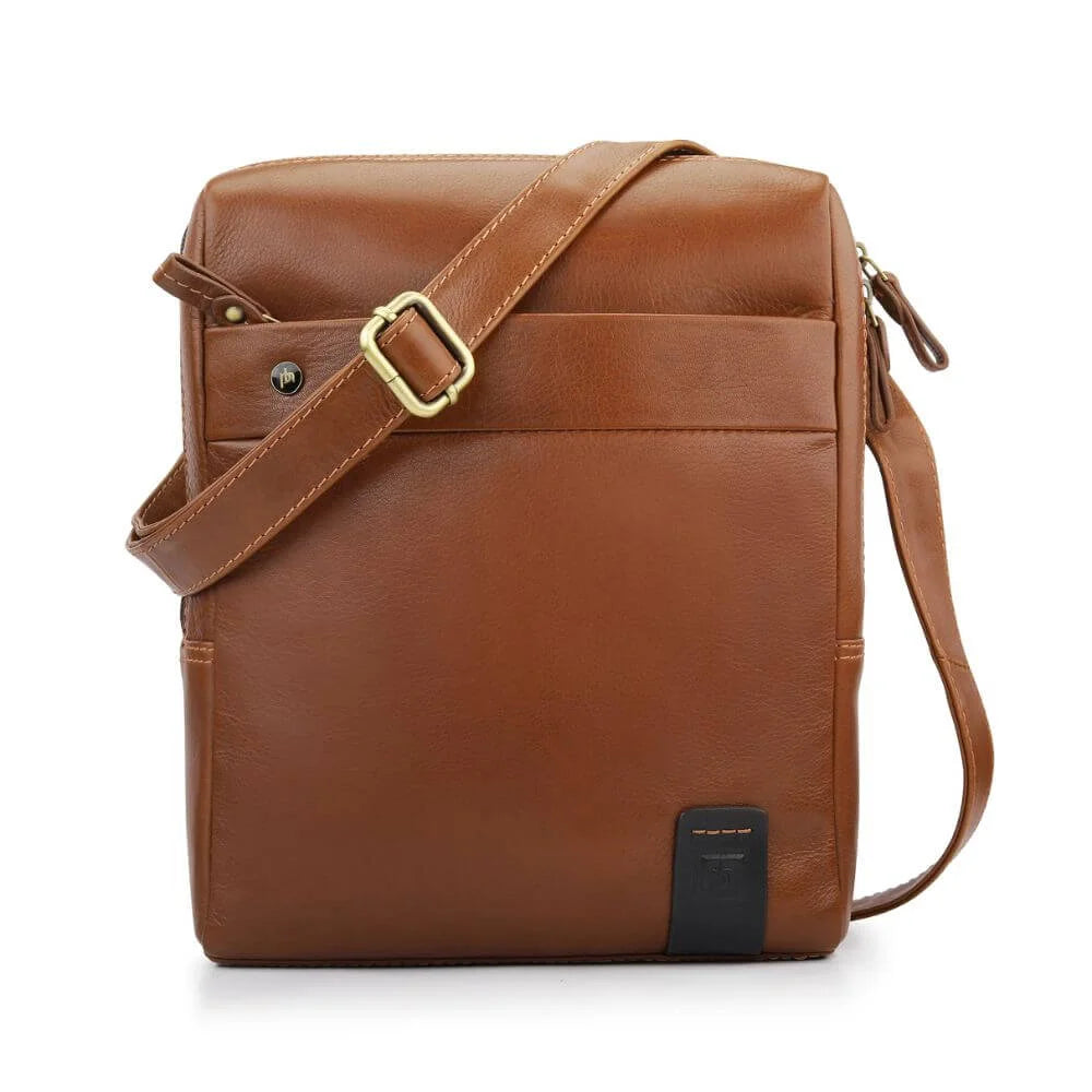 Chestnut leather messenger bag with clean design and adjustable strap, part of the Tuscan collection.