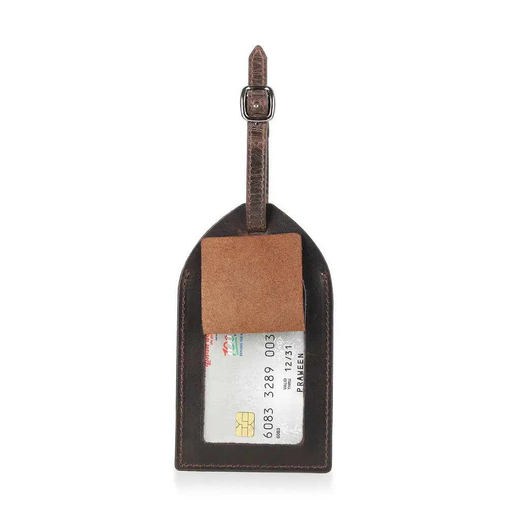 Top view of brown leather luggage tag showing transparent ID window and secure buckle strap.