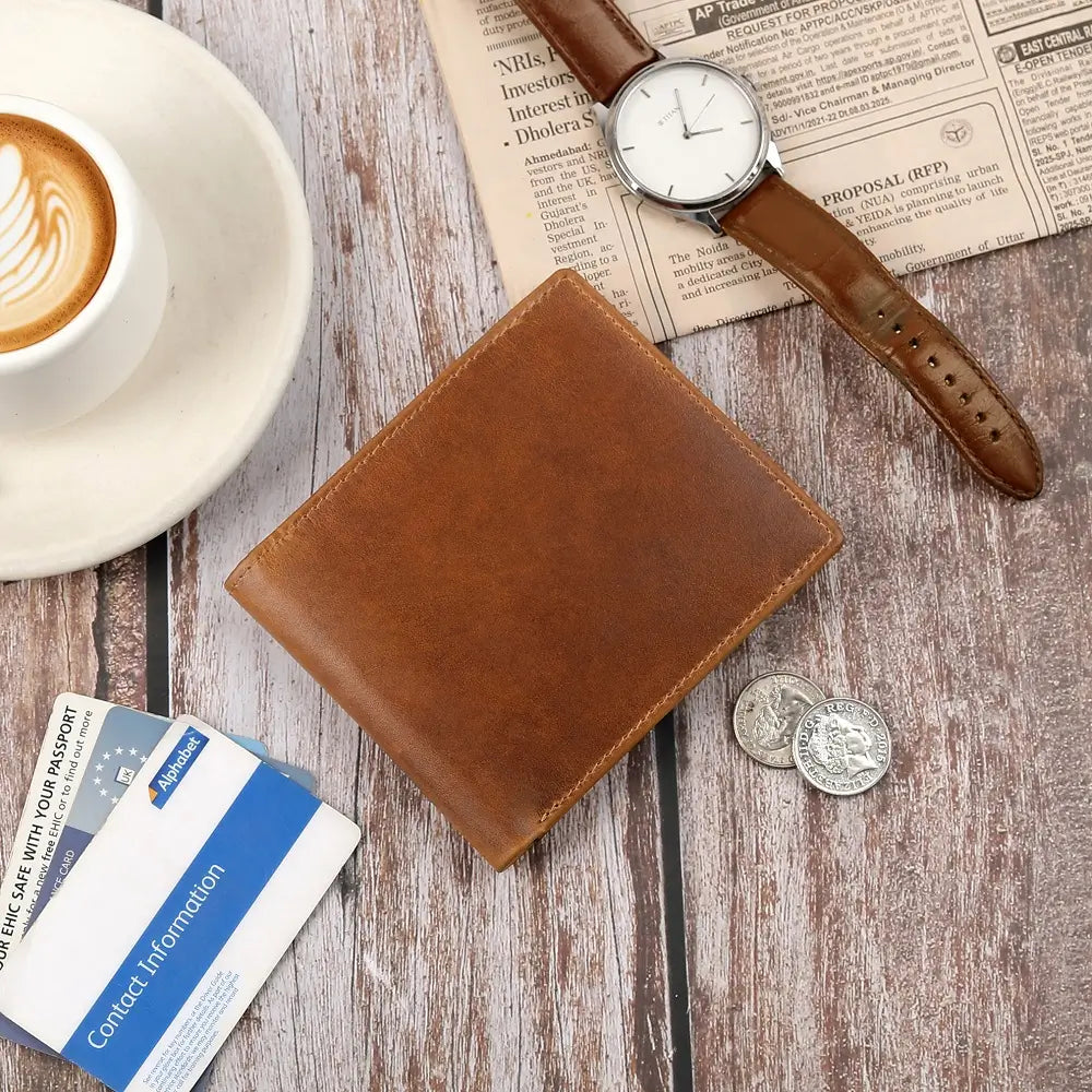 Tan leather bifold wallet styled neatly with classic accessories on a desk
