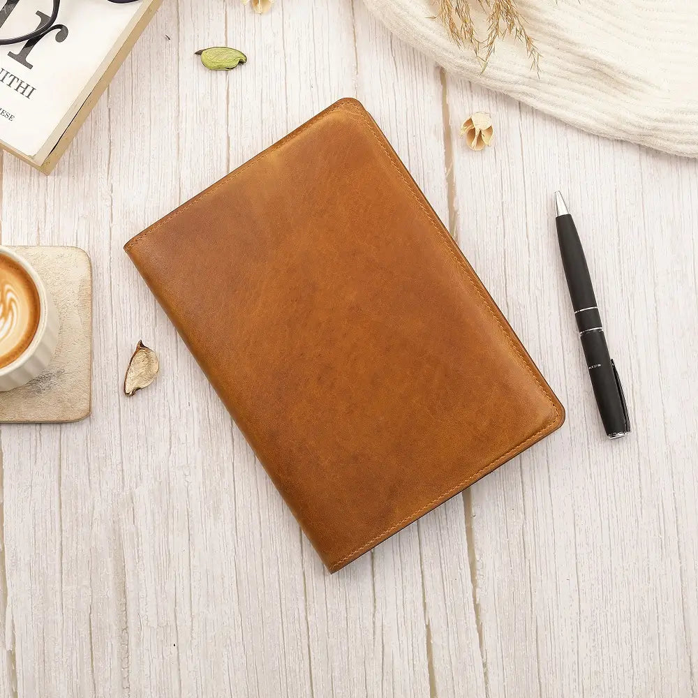 Tan Leather Diary Cover Mayfair 2519 placed on a desk beside a pen and notebook in a warm lifestyle setting.