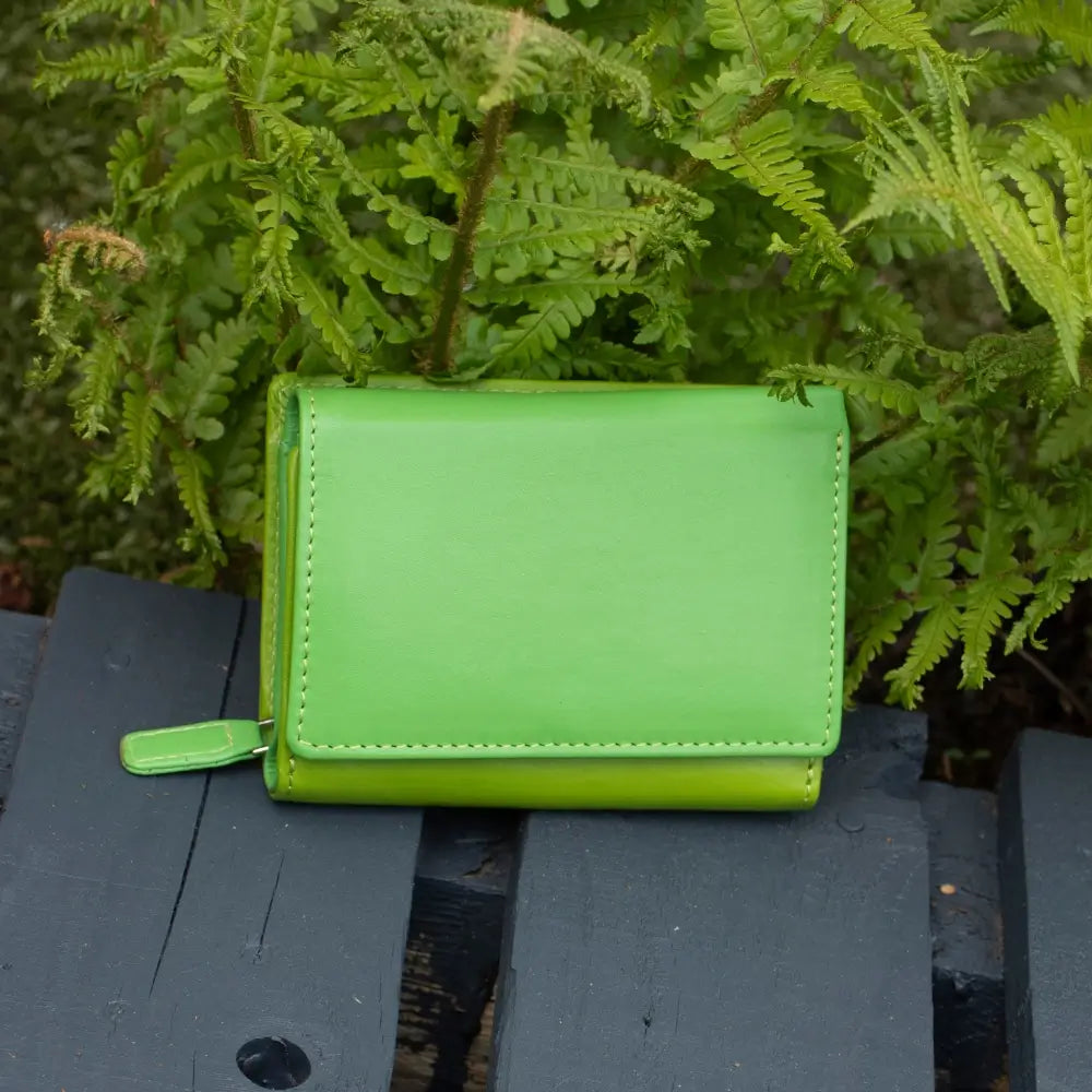 Front view of green RFID Secure trifold leather purse with tab closure and coin pocket