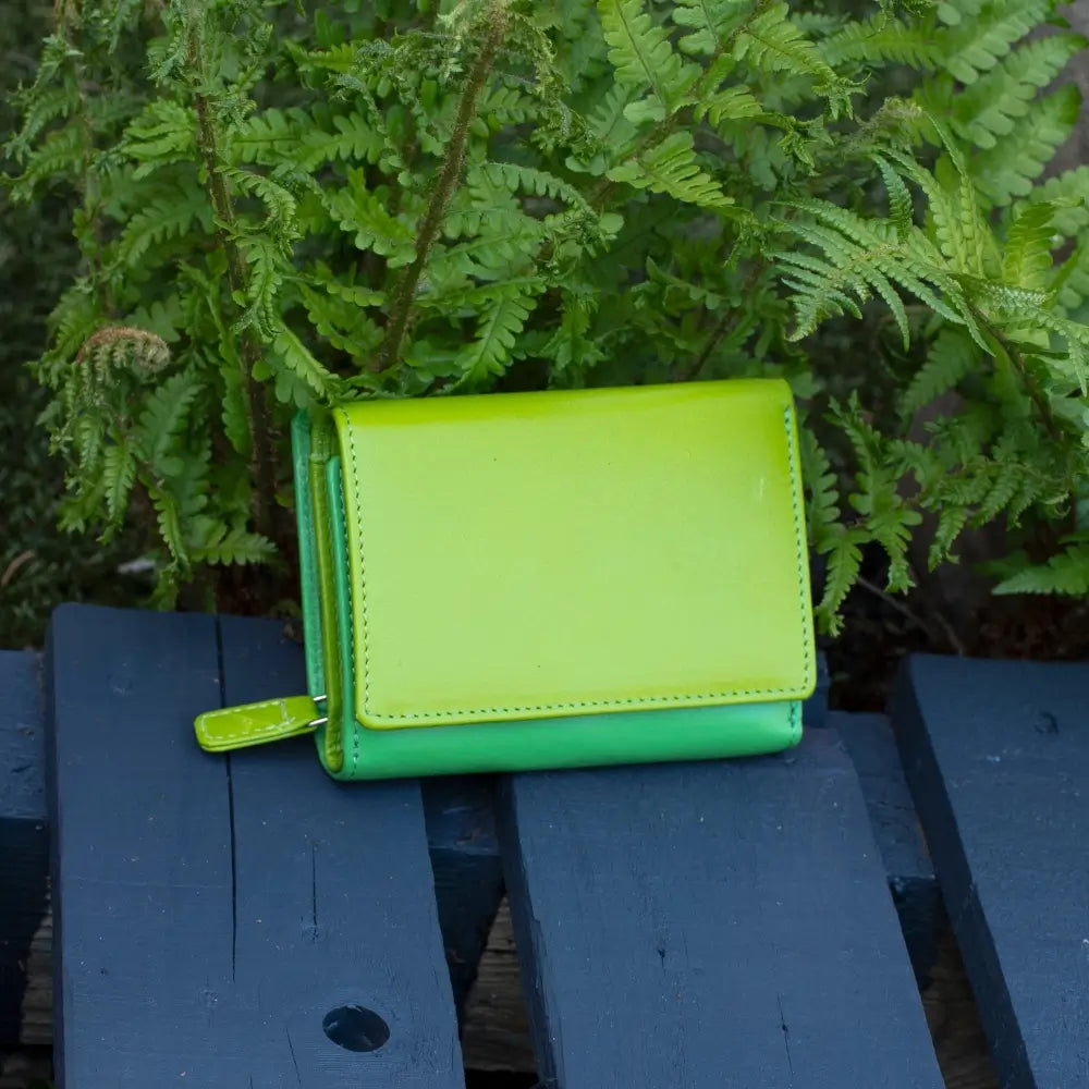 Front view of lime RFID Secure trifold leather purse with tab fastener and zipped coin pocket