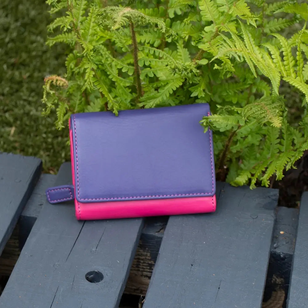 Front view of purple RFID Secure trifold leather purse with tab closure and zipped coin pocket