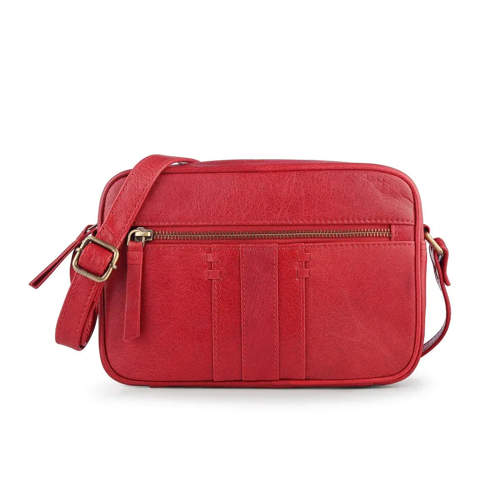 Front view of the red leather small crossbody bag on a white background, highlighting its front zipped pocket and detailed stitching.
