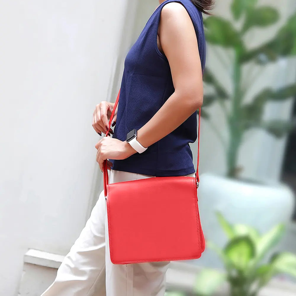 Lifestyle image showing a person carrying the Large Organiser Bag in red leather.