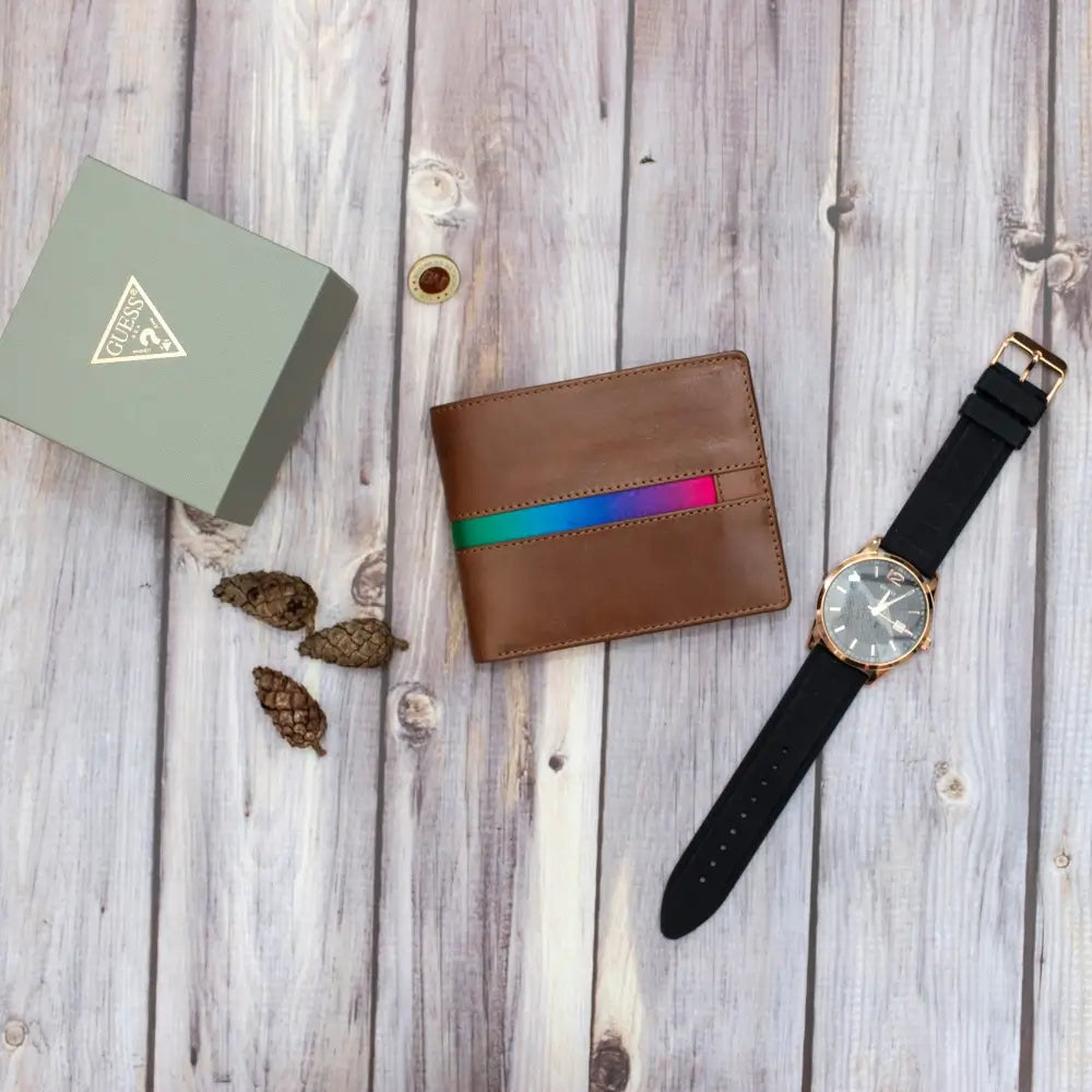 Brown leather wallet with colorful stripe and black watch on wooden surface