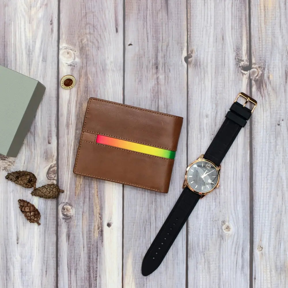 Brown wallet with rainbow stripe and black watch on wooden surface
