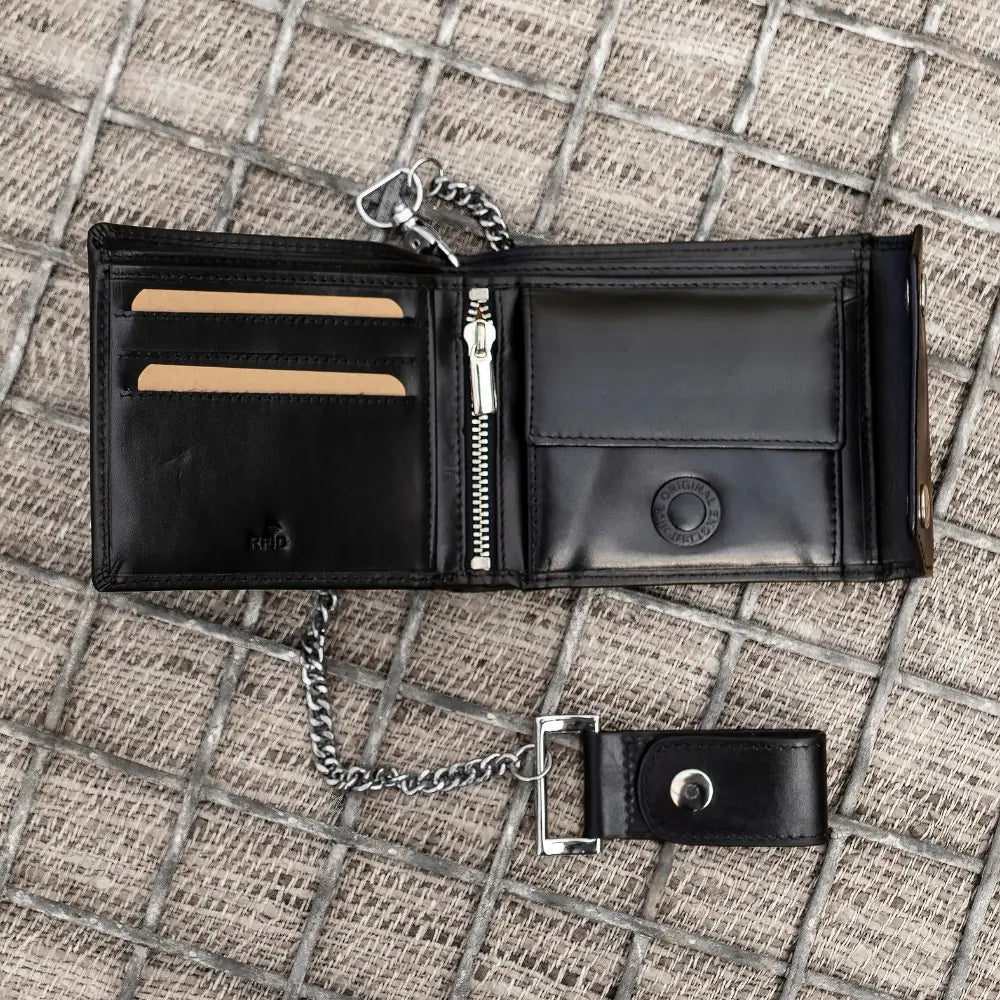 Black leather wallet with chain on a textured surface