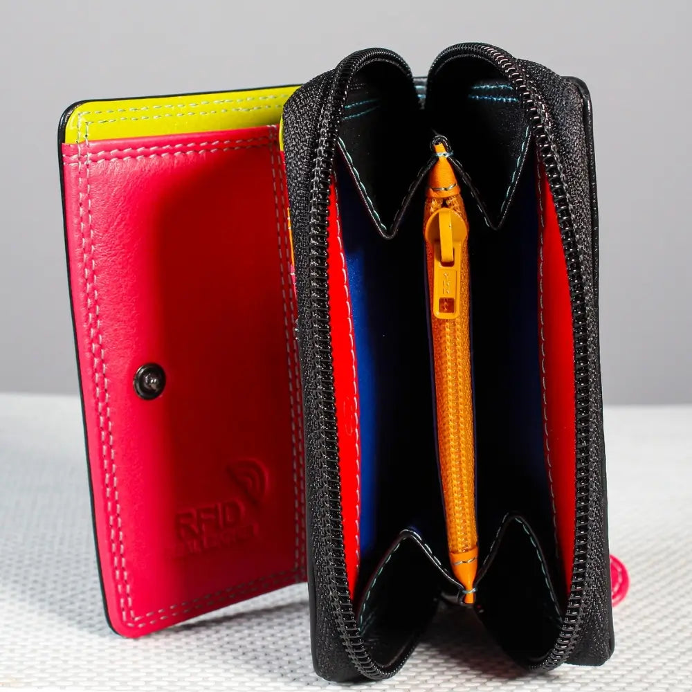 Black leather wallet with red interior and yellow pen on a gray background