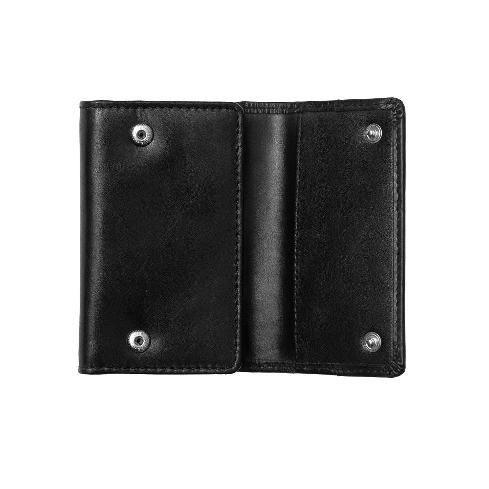 Open view of Black leather key chain with metal grommets on a white background