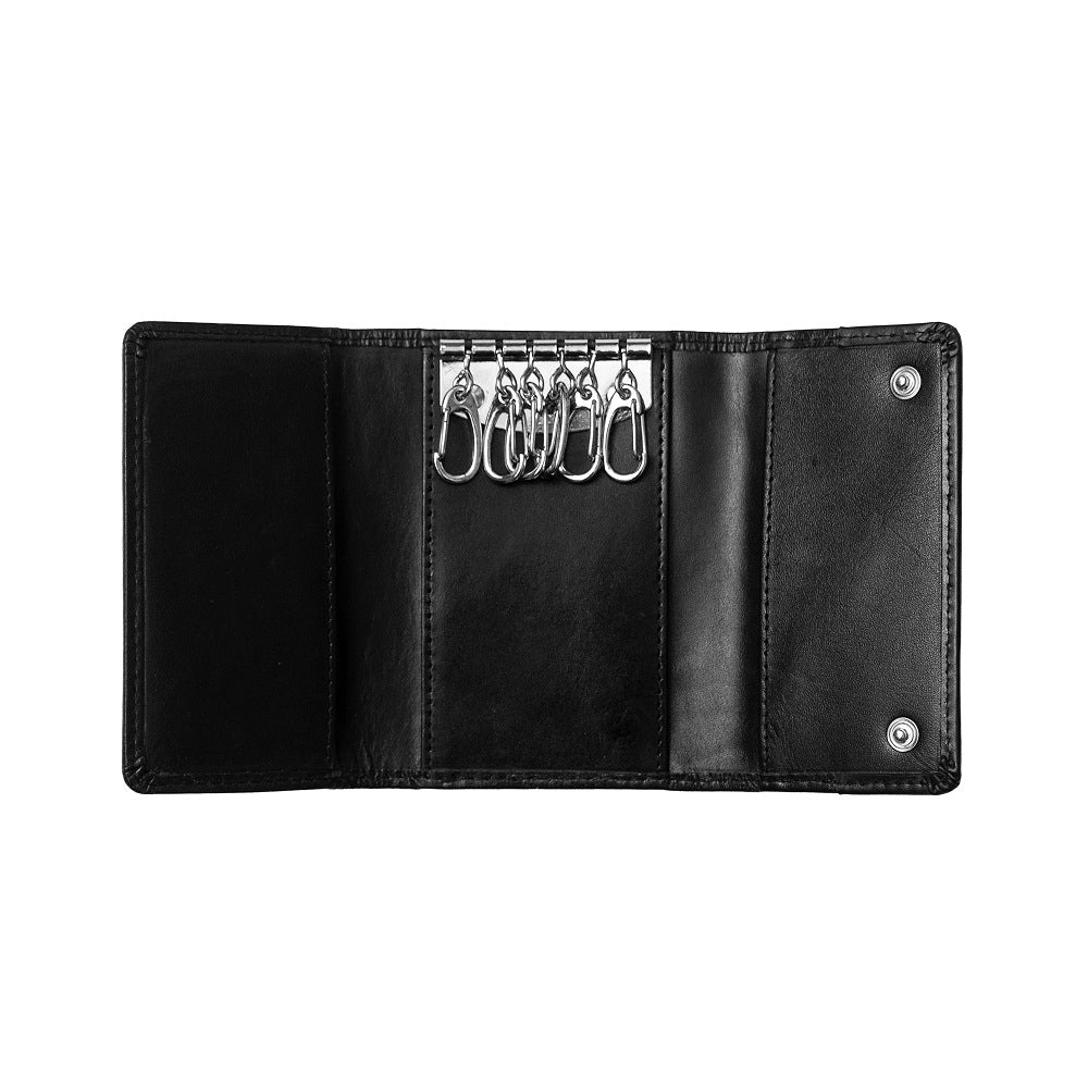 Black leather key organizer with multiple keys on a white background