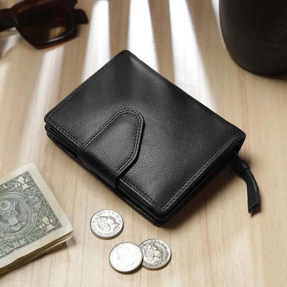 Black leather wallet with coins and money on a wooden surface