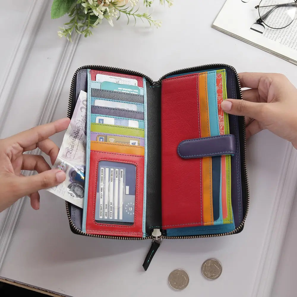 Black purse with card slots and a coin compartment on a light surface.