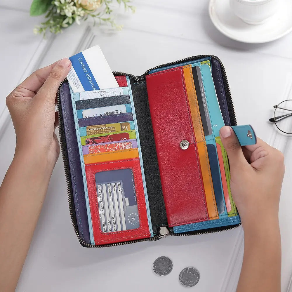 Black purse with multiple card slots held by hands on a light surface.