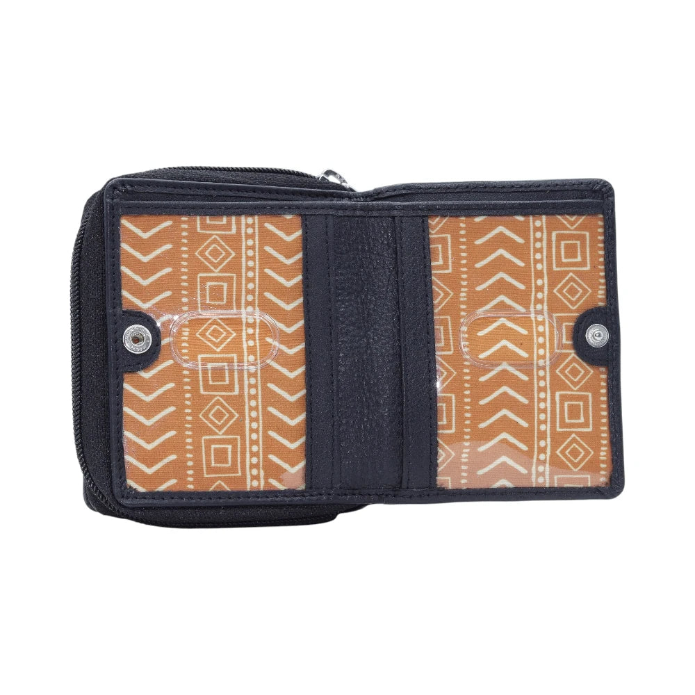 Black purse with orange and white patterned interior on a white background