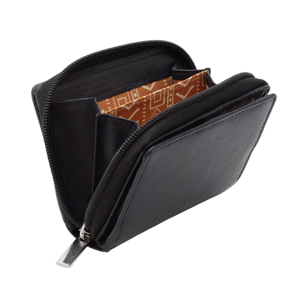 Black leather purse with a patterned interior on a white background
