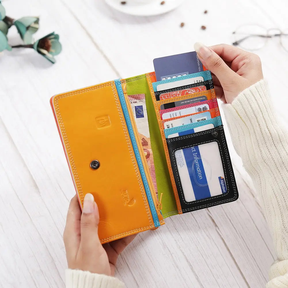 Lifestyle view of Black wallet with orange bottom section on a white background
