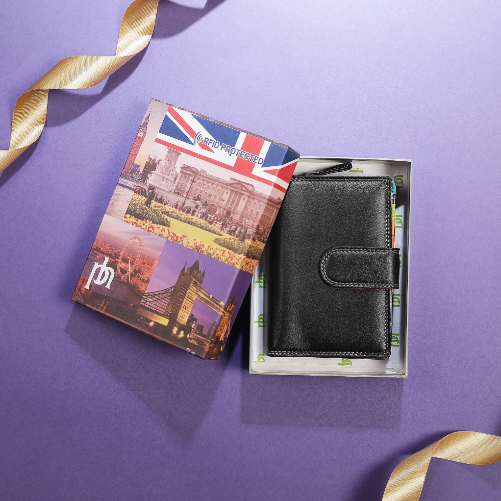 Black wallet in packaging with a travel-themed card holder on a purple background