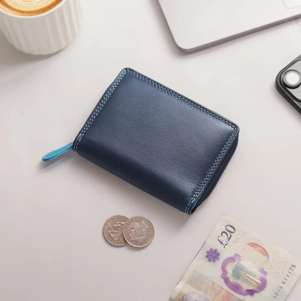 Blue wallet with coins and money on a light surface
