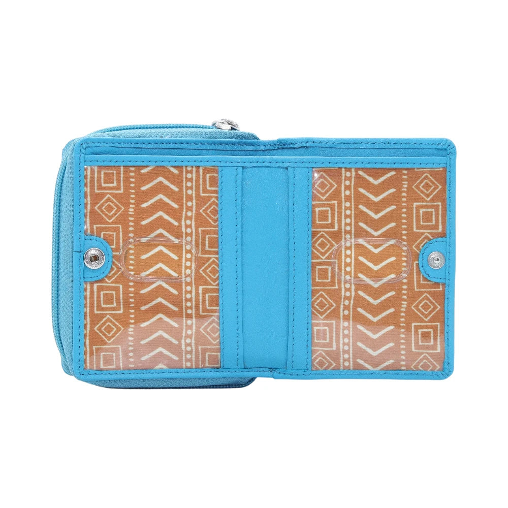 Open view of Turquoise purse with brown patterned flap on a white background