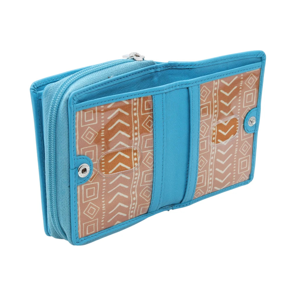 Open view of Turquoise purse with a patterned interior on a white background