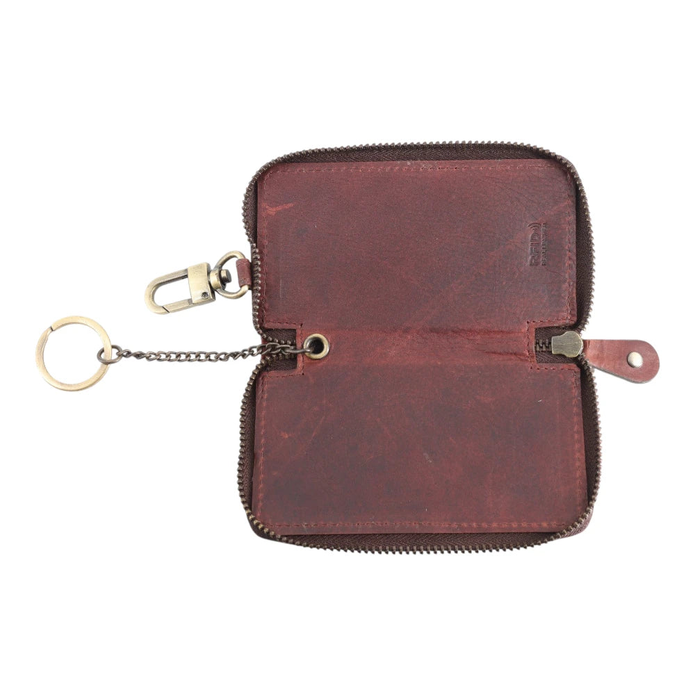 Brown leather key case with keychain on a white background