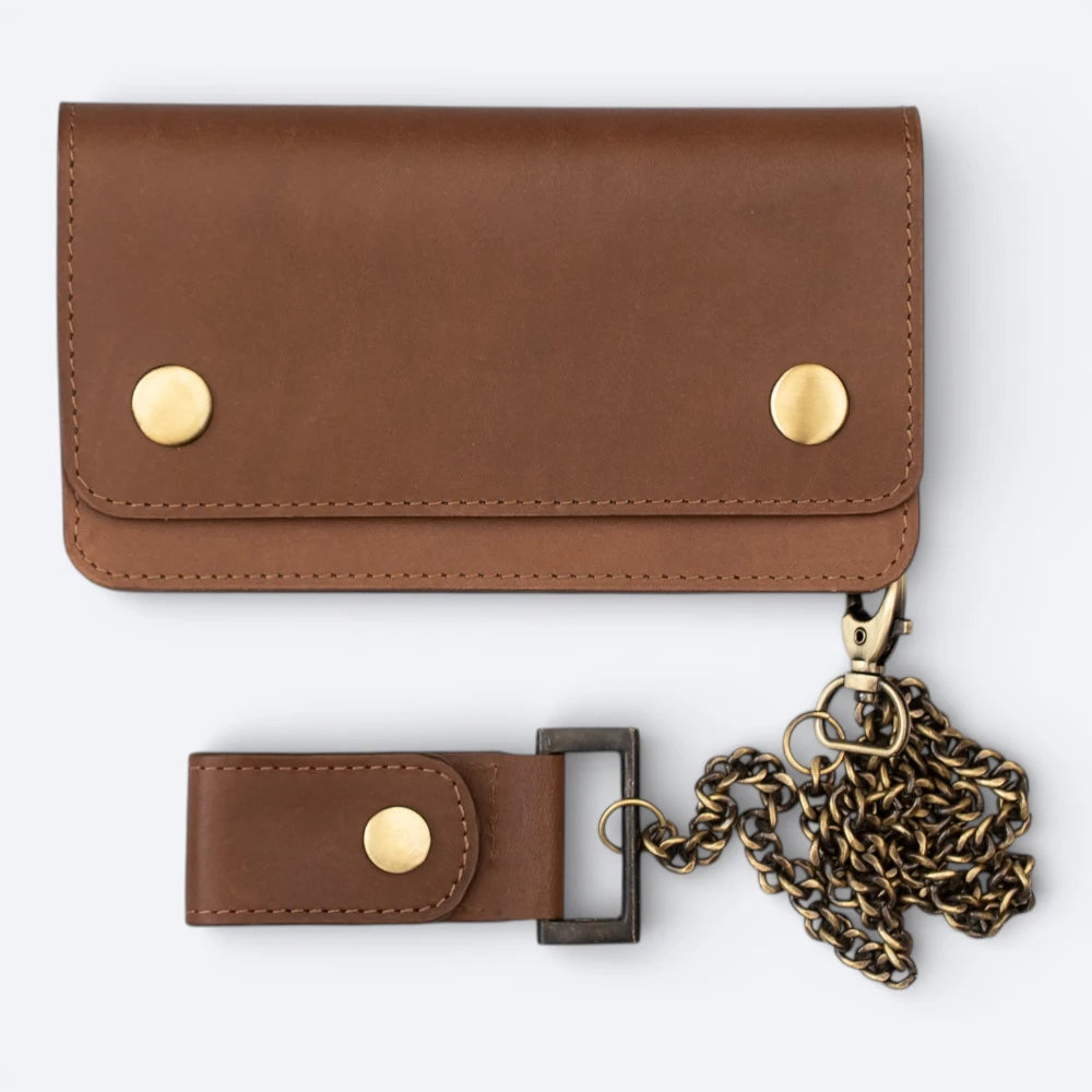 Brown leather wallet with gold accents and a chain on a white background