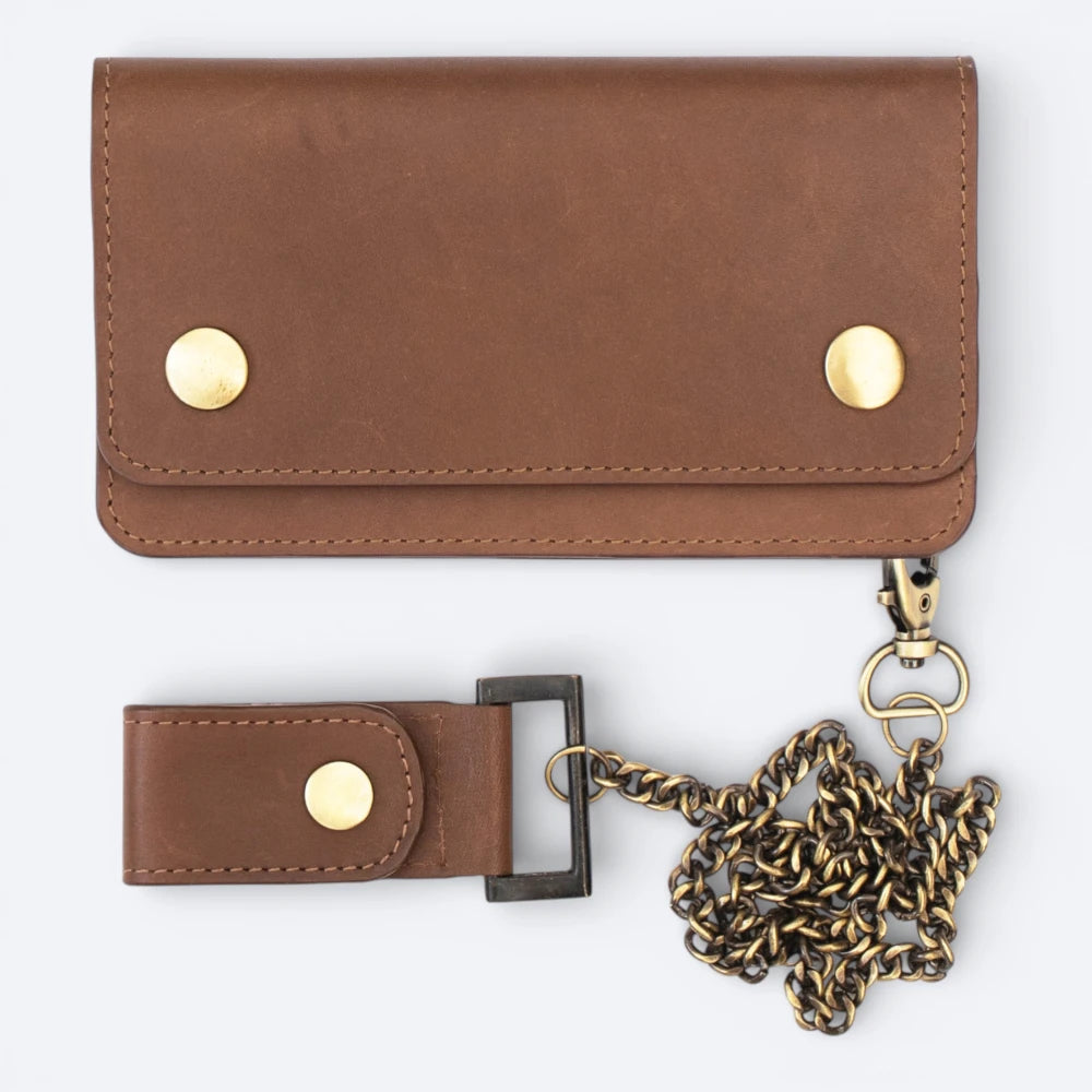 Brown leather wallet with gold accents and a chain strap on a white background