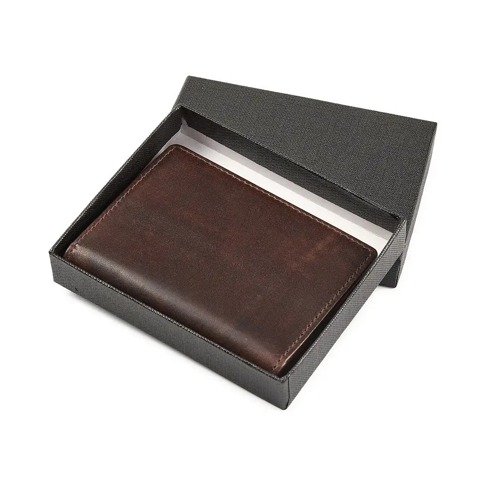 Brown leather credit card holder in a black box on a white background