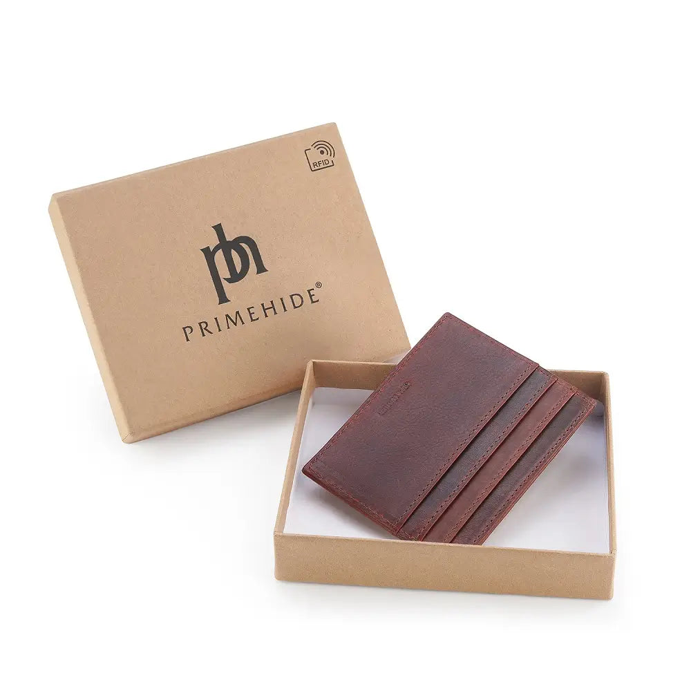Brown leather card holder in a Primehide branded box on a white background