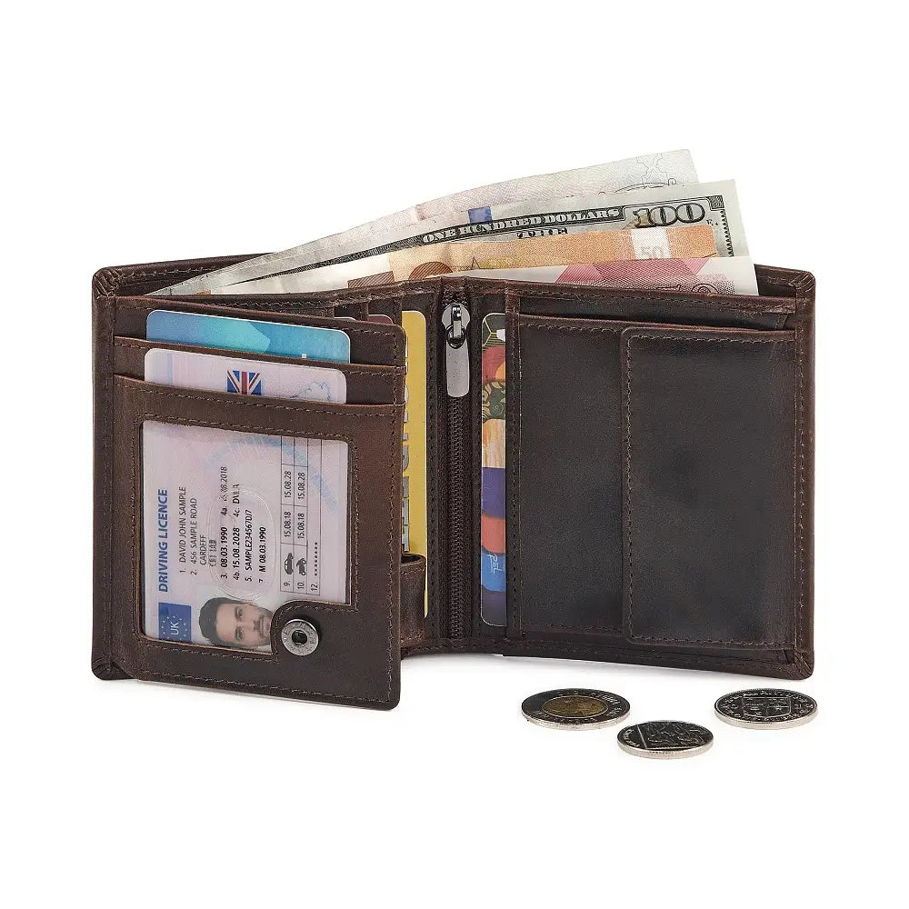 Open brown leather wallet with money, cards, and coins on a white background