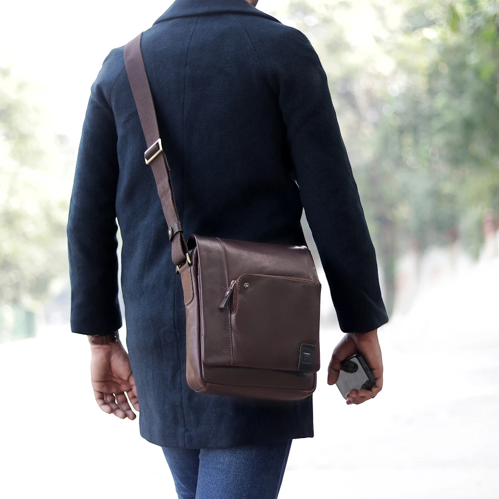 Brown leather shoulder bag on a white background