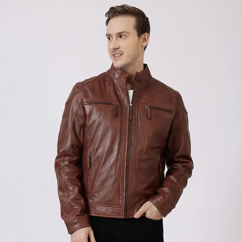 Man wearing a cognac leather jacket on a light gray background