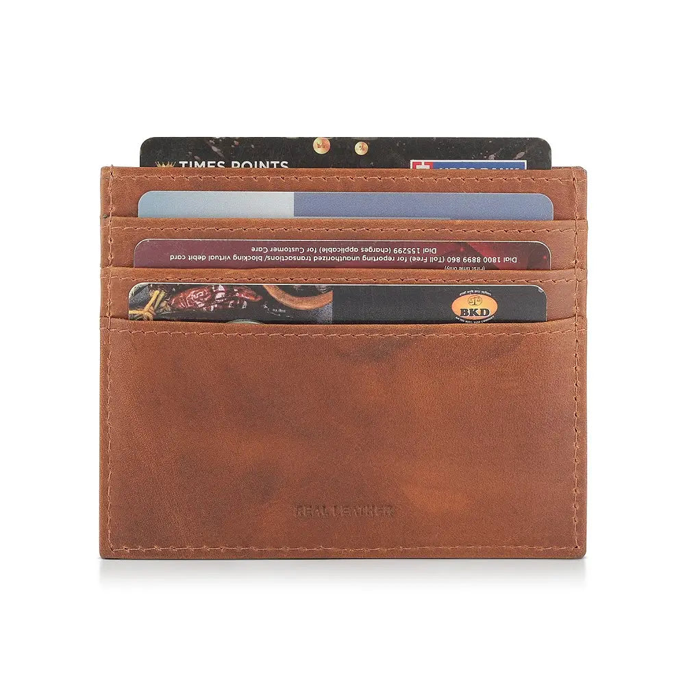 Cognac leather card holder with multiple cards inserted on a white background