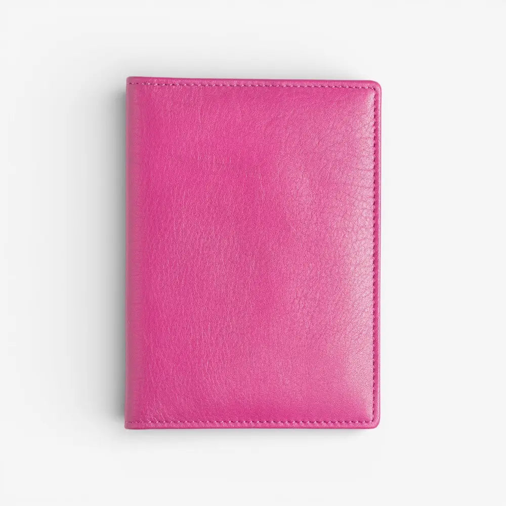 Fuchsia leather passport holder on a white background