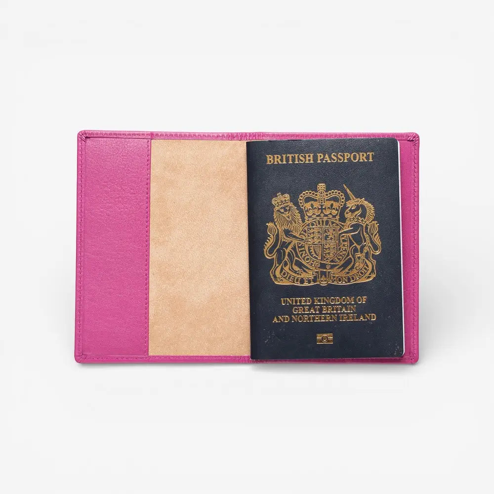 Fuchsia passport holder with a British passport inside on a white background