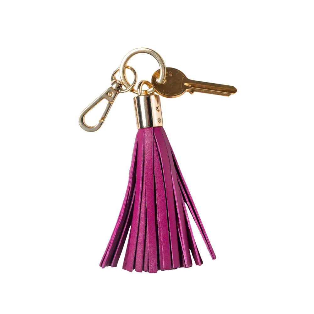 Keychain with Fuchsia tassel and gold accents on a white background