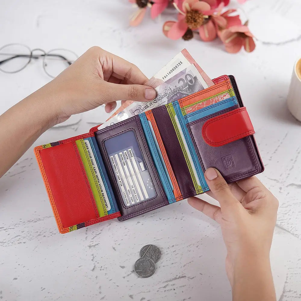 Grape wallet with money and coins on a light surface