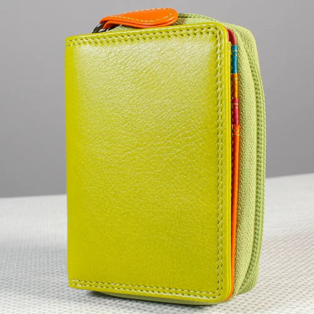 Green wallet with colorful zipper on a gray background