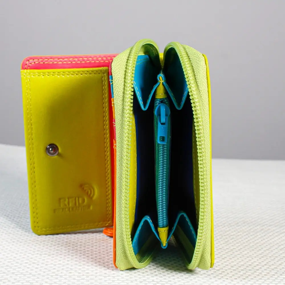 Green wallet with a pen inside on a textured surface