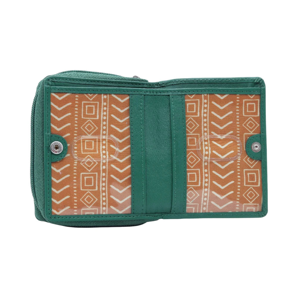 Green purse with tribal pattern on a white background