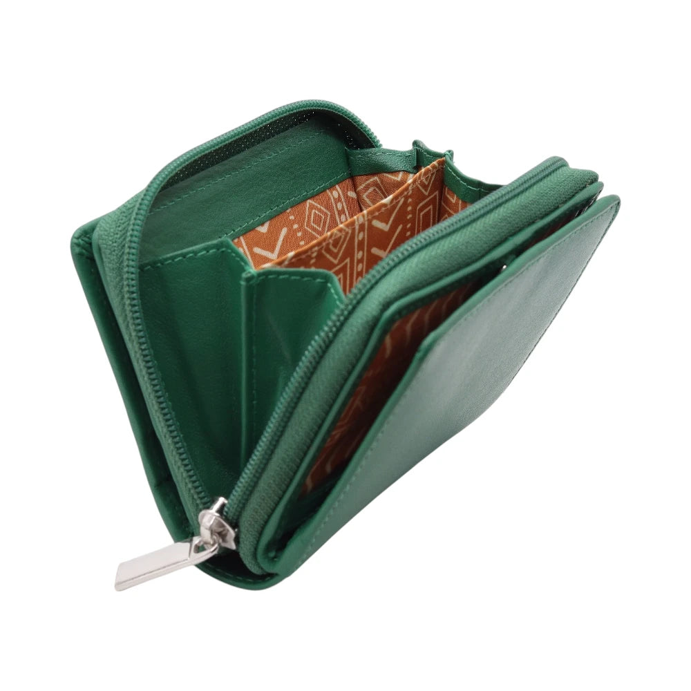 Green purse with a patterned interior on a white background