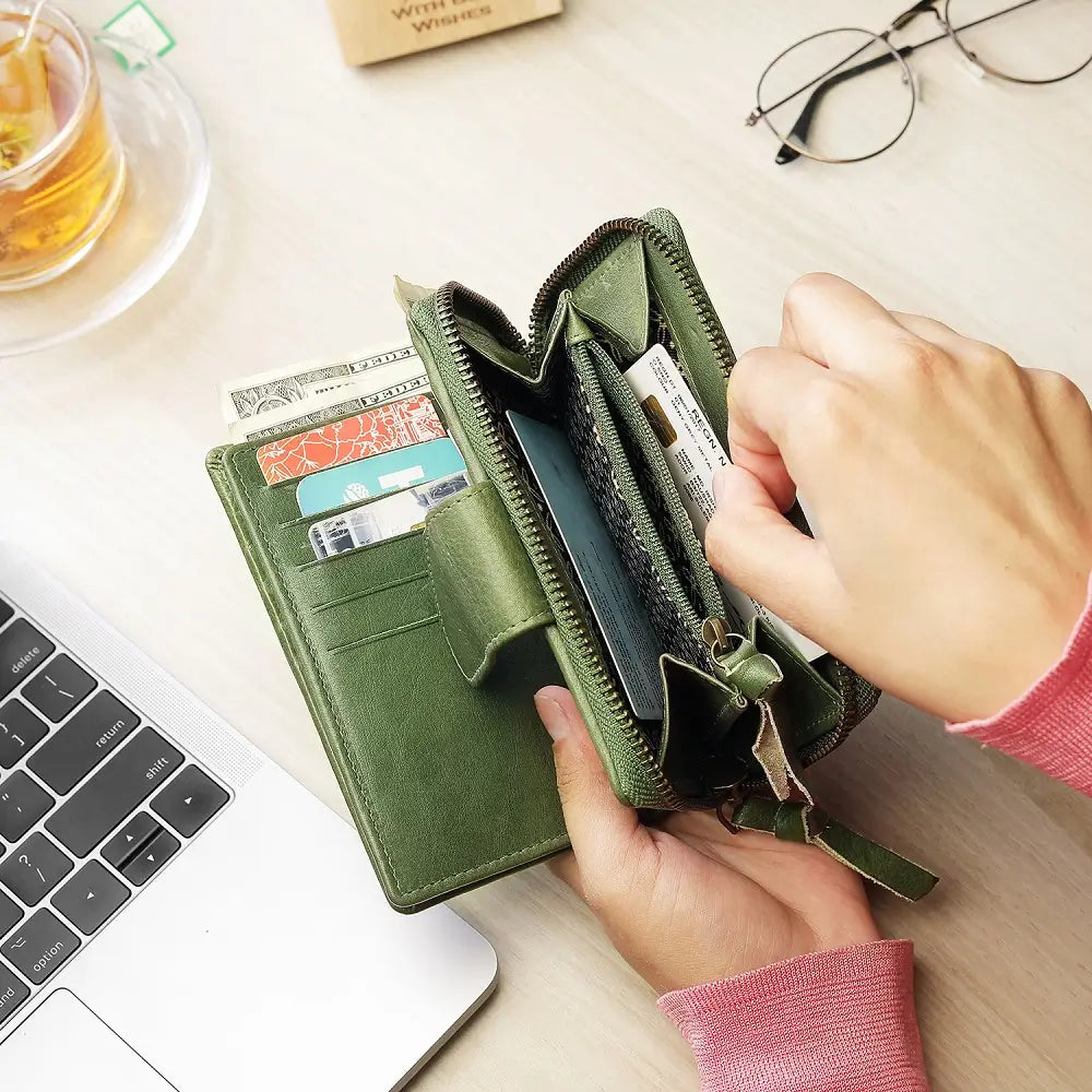 Green wallet being used with a laptop and tea in the background