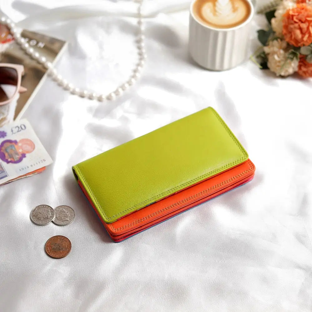 Lifestyle view of Green wallet with orange bottom section on a white background