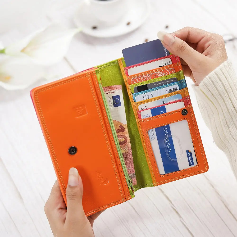 Person holding  Green wallet with orange bottom section on a white background