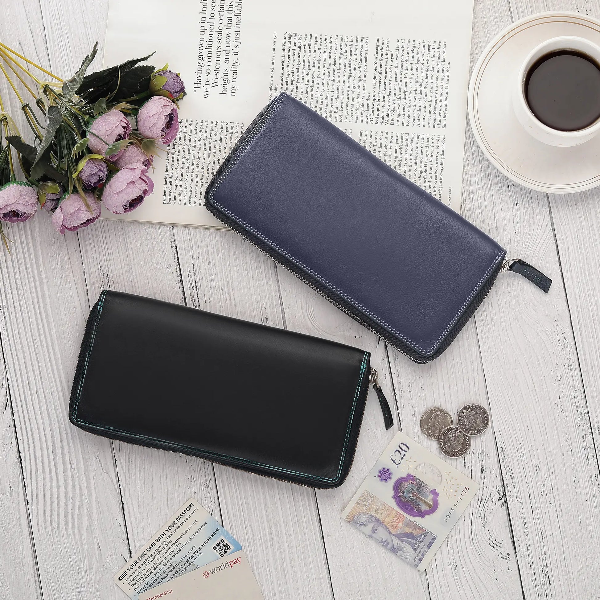 Two wallets, one black and one navy, on a wooden surface with coins and banknotes.