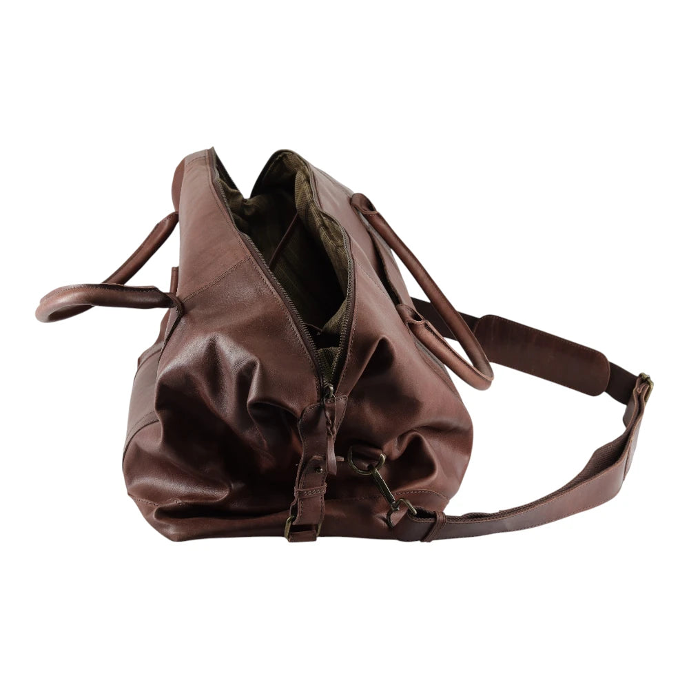 Brown leather bag with a shoulder strap on a white background