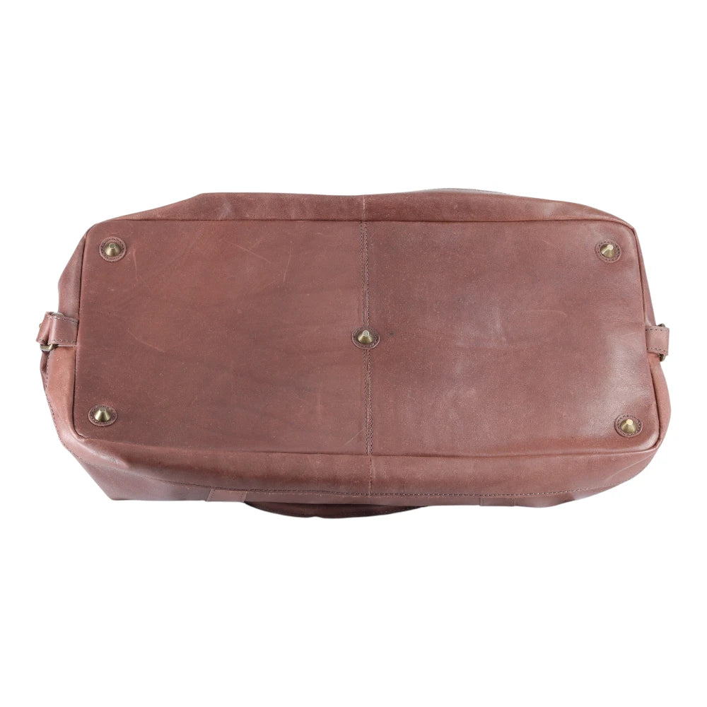 Brown leather bag with gold studs on a white background