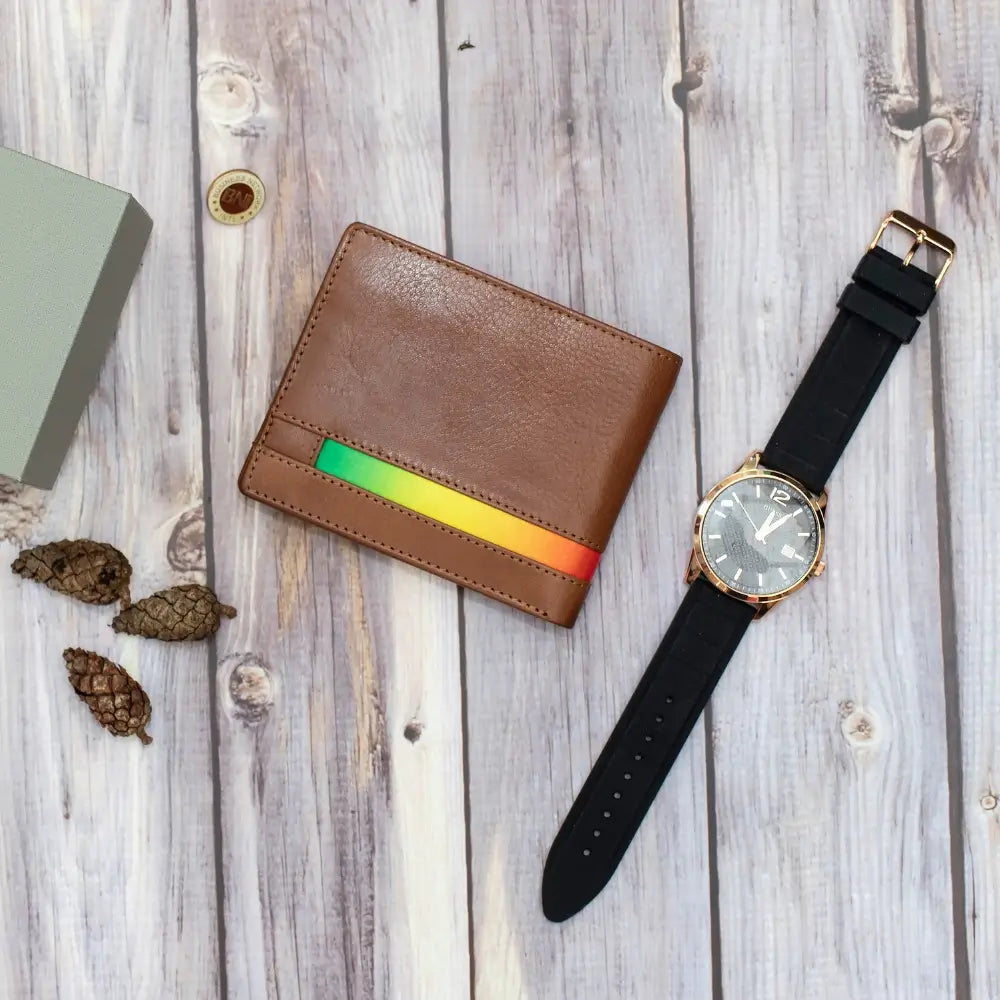 Brown wallet with rainbow stripe and black watch on wooden surface